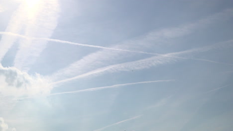 uk october 2018 - time lapse of aircraft leaving vapour trails as they pass high overhead and drift through an early morning sky