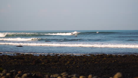 surfer surfing on breaking wave in tropical island