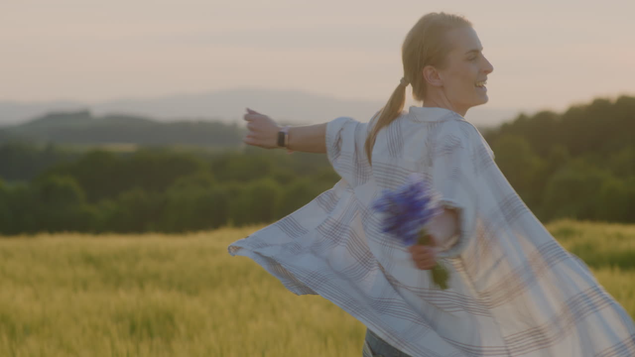 Portrait of Happy Woman Dancing at Sunset and Rural Landscape