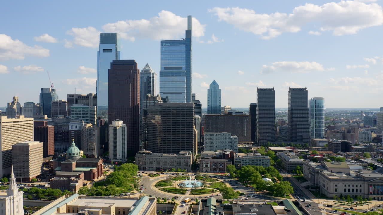 Aerial drone flying left through Philadelphia city skyline showcasing Comcast Technology Center, Logan Square, and Ben Franklin Parkway