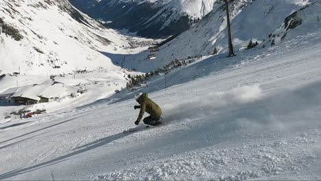 Male-ski-athlete-showing-downhill-skiing-on-a-steep-ski-slope-with-high-speed-and-great-ski-style