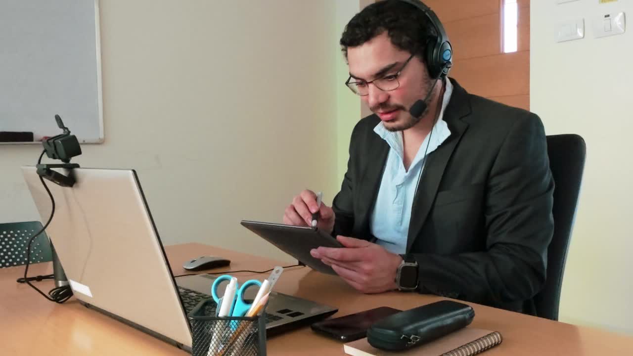 Engaging in Webinar: Man Notes on Tablet