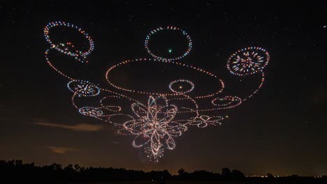 a stunning display of colorful lights in the night sky: a captivating showcase of mysterious patterns and shapes formed by drones in an enchanting aerial performance