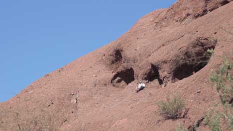 a couple takes a selfie at the hole in the rock landmark, papago park, phoenix, arizona