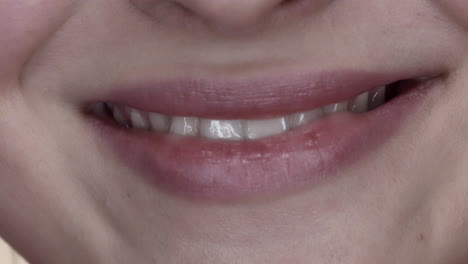 macro closeup on white of young woman smile