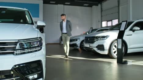 man walking through car showroom