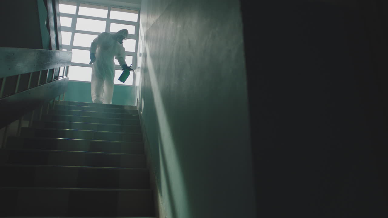 Disinfection of stairs with hazmat suit