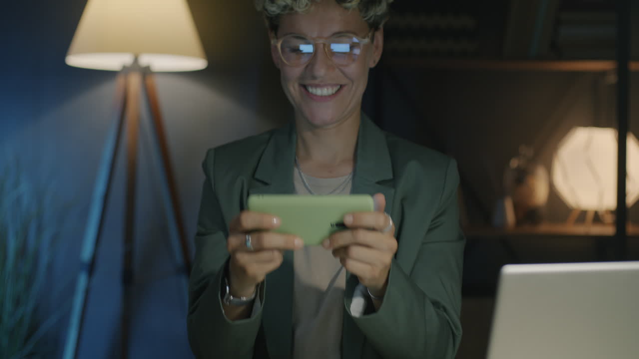 Woman Playing Mobile Game at Night