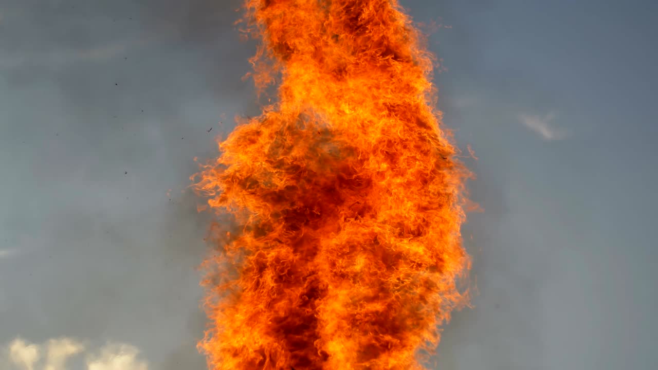 Tongues Flame of a Large Fire in the Evening against the Sky