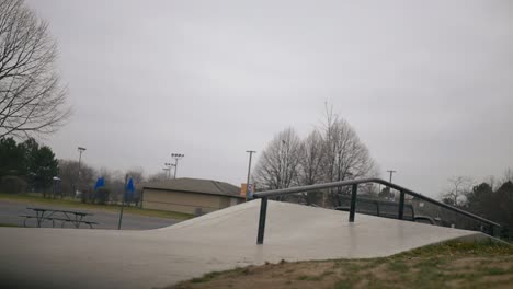 Skateboarder-does-a-flip-trick-into-a-slide-on-the-handrail