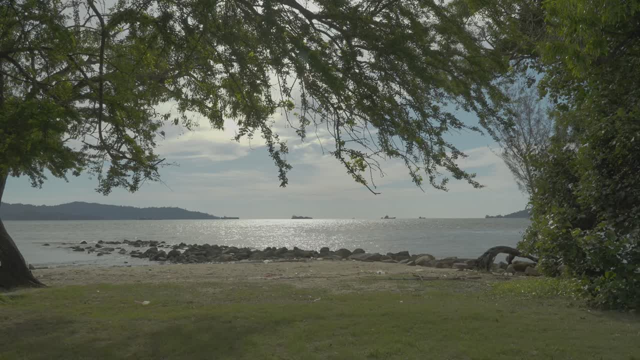 Summer Beautiful View Of Teluk Likas Beach, White Sandy Beach, Small Island, Blue sea water And Green Trees,Kota Kinabalu,Sabah,Malaysia.
