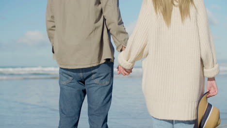 young caucasian couple standing at seashore