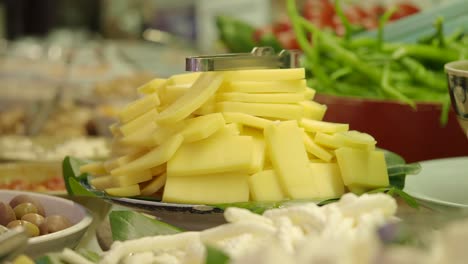 large pile of sliced cheese at a buffet