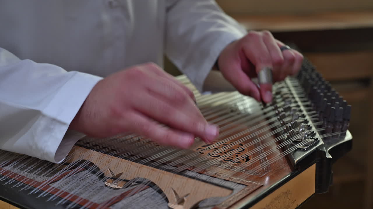 An Arab musician plays the qanun, producing intricate melodies that define the soul of Arabic music