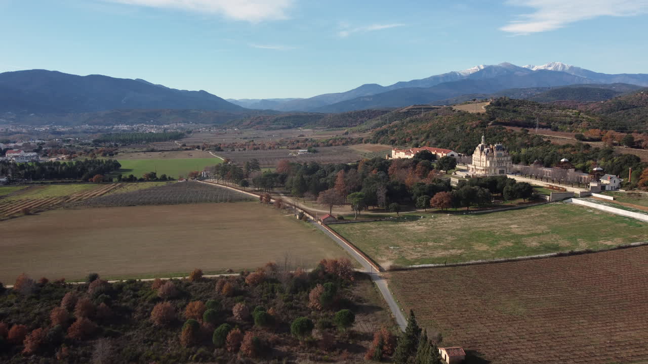 Aerial view of a valley with a castle and farmland