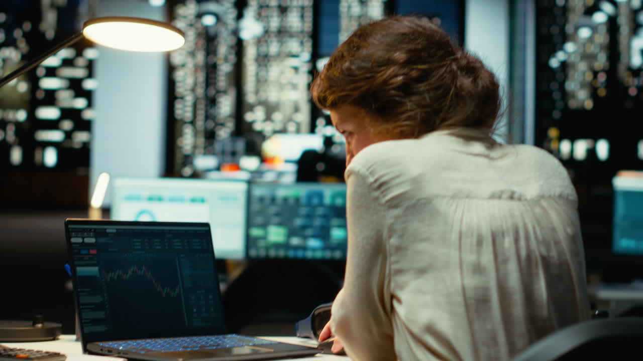 Vertical Video Professional worker in office monitors stock trends and candlestick charts