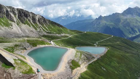 Aerial-backwards-shot-of-idyllic-mountains-lakes-in-Austria-during-sunny-summer-day