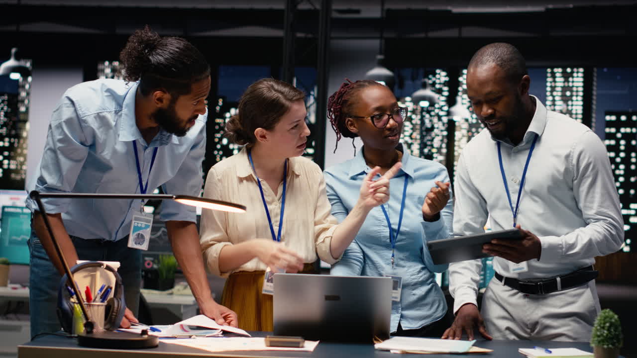 Multiethnic team collaborating in modern office workspace at night