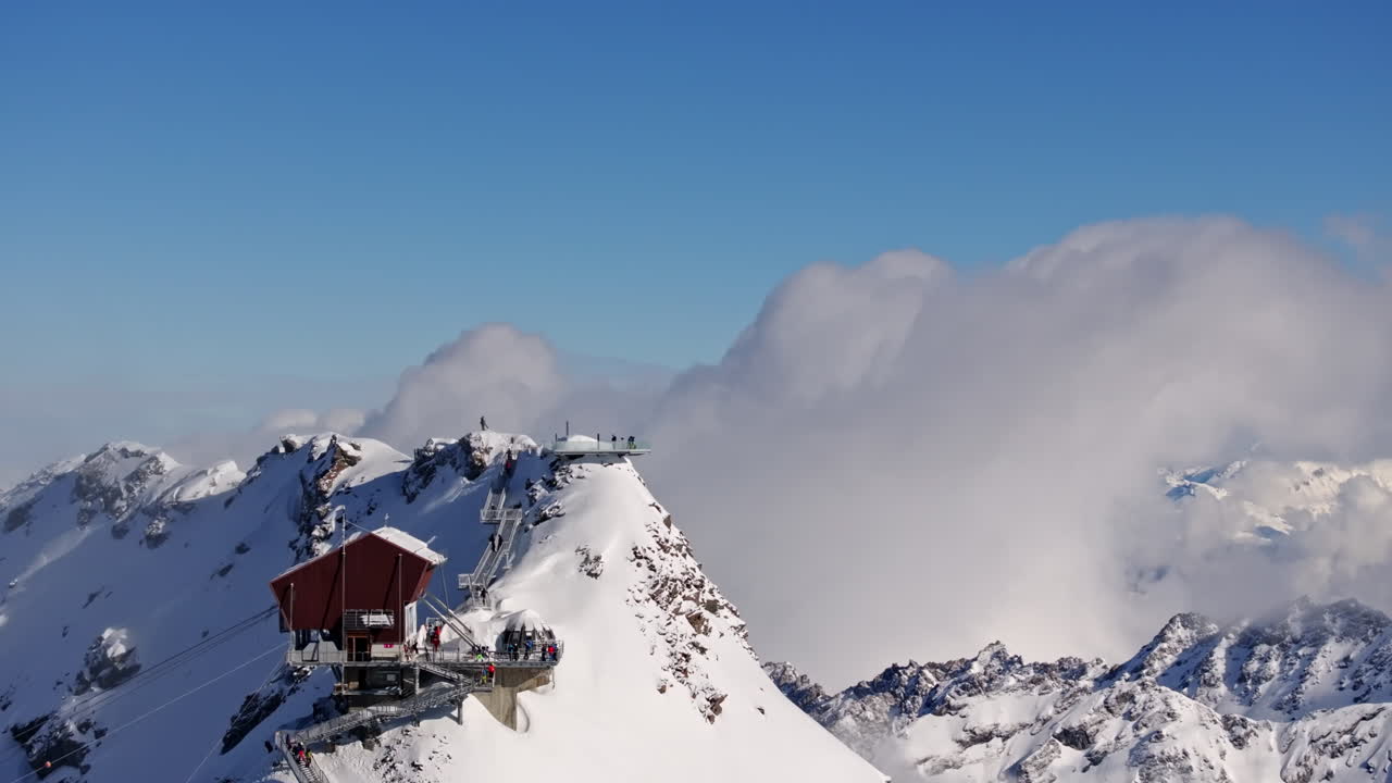 Aerial footage of the iconic freeride paradise of Verbier on a stunning bluebird day. Snow-covered peaks, wide open faces, and legendary off-piste terrain under clear alpine skies