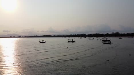 AERIAL:-Fishing-Boats-Moored-off-the-Coast-at-Sunset