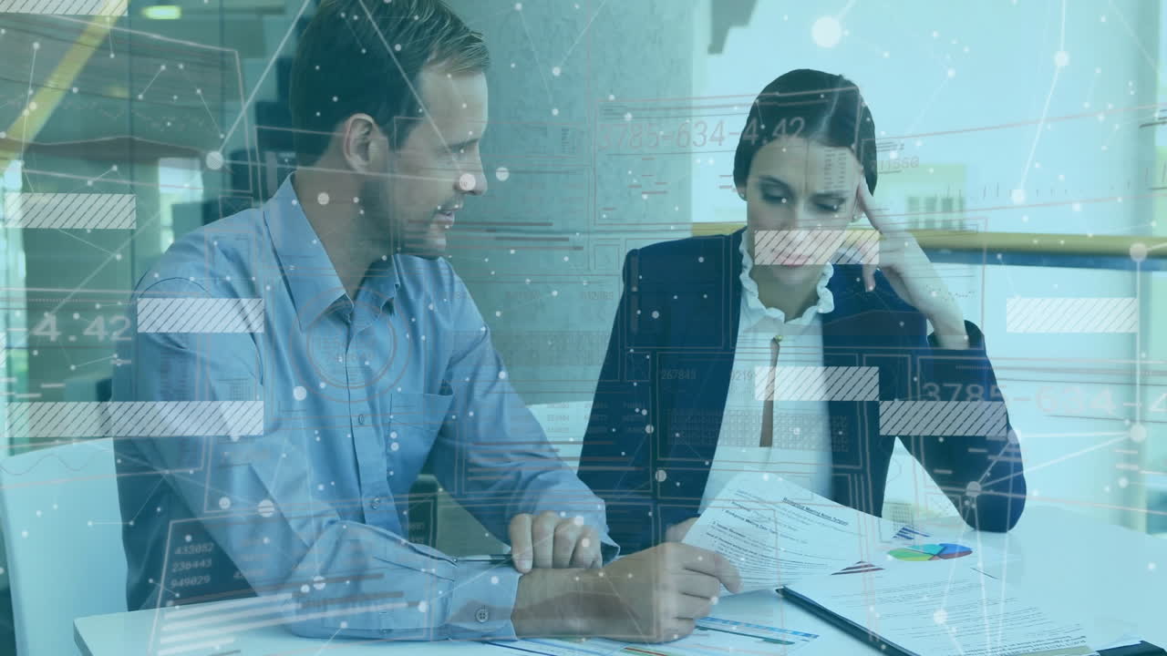 Reviewing documents, business professionals with data processing animation overlay in office