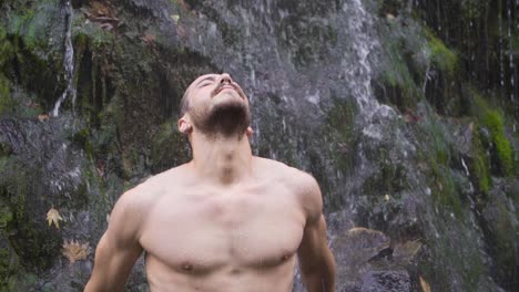 Muscular-man-and-waterfall.-Slow-motion.