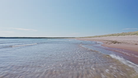 waves lapping and crashing on a sandy beach