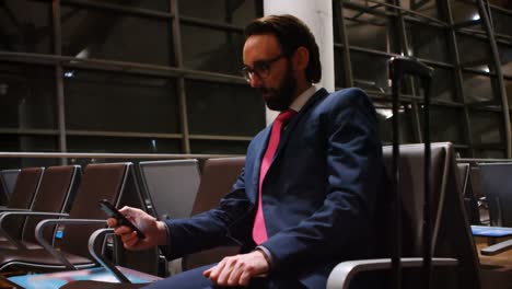 commuter using mobile phone in waiting area 4k