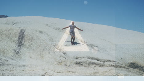 animation of glowing circles and triangles over fit african american senior man walking on dunes