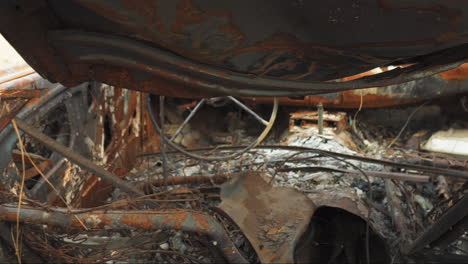 interior of a burned and corroded rusty car