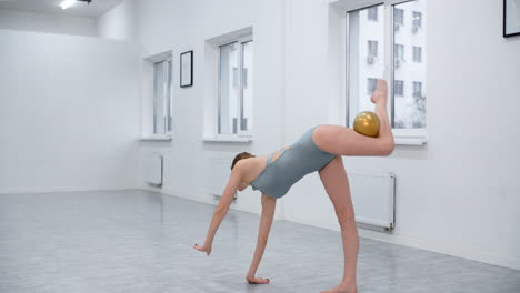 woman performing gymnastics ball exercise