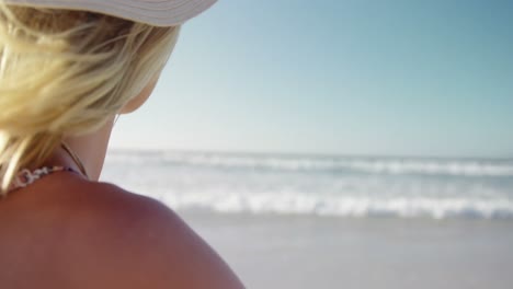 Woman-standing-at-beach-on-a-sunny-day