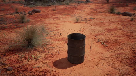 old-empty-rusted-barrel-on-sand