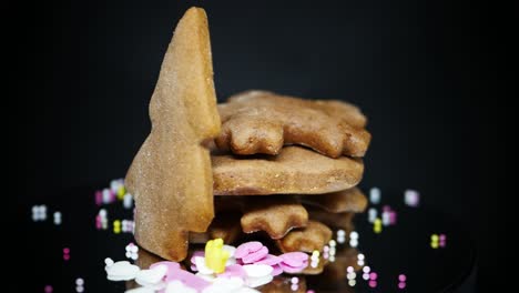 Gingerbread-Biscuits-With-Candy-Sprinkles-On-Black-Background