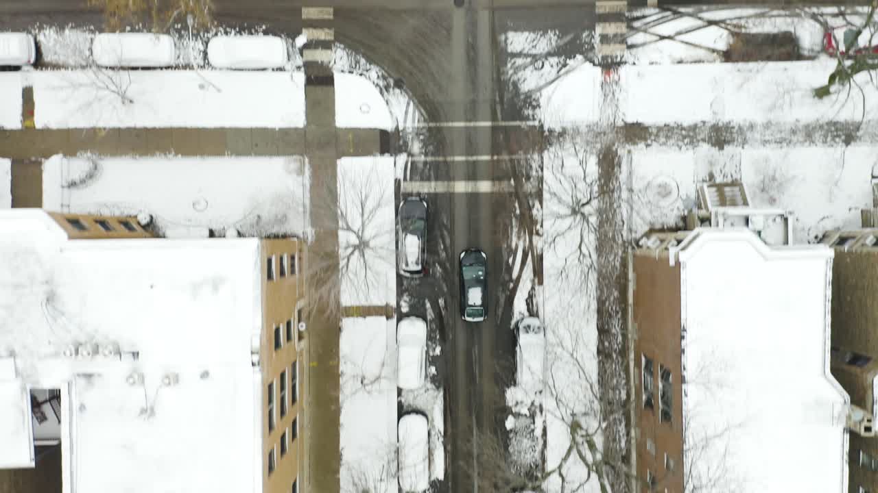 Aerial, Tracking Shot of Black Car Driving during Winter in City Neighborhood