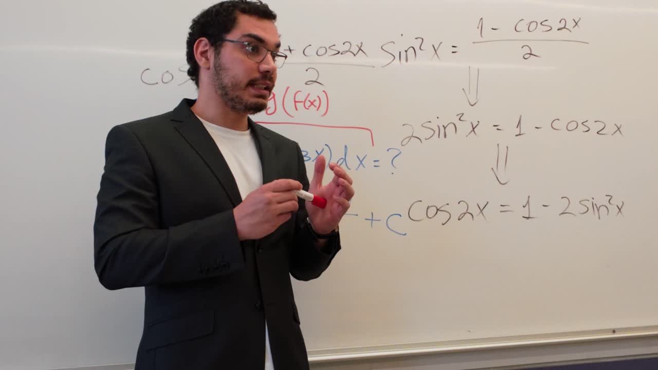 Teacher Demonstrating a Problem on a Whiteboard