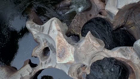 ascending aerial hd drone footage of a bird's-eye view of the blyde river flowing through the base of bourke's luck potholes in graskop, mpumalanga, south africa