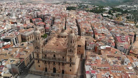 Spain-Jaen-Cathedral,-Catedral-de-Jaen,-flying-shoots-of-this-old-church-with-a-drone-at-4k-24fps-using-a-ND-filter-also-it-can-be-seen-the-old-town-of-Jaen