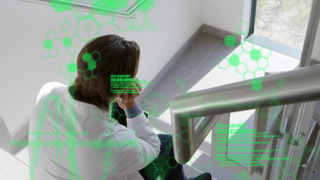 Mid adult man making phone call at stair landing, showing AR interface with green hexagon overlay