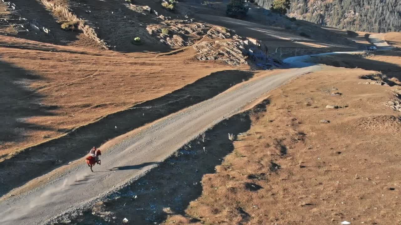 Rider on horseback travels across rocky terrain in Georgia, Caucasus