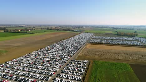 Aerial-footage-of-finished-cars-ready-to-be-shipped-on-huge-distribution-center