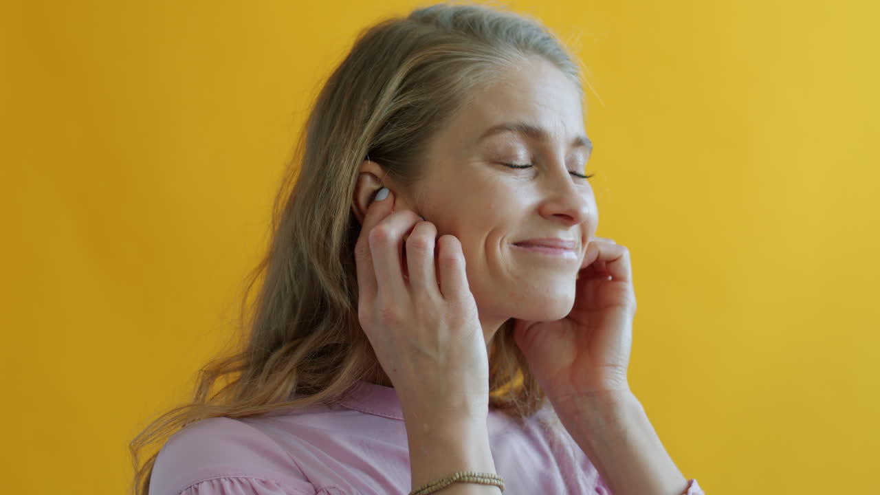 Woman Wearing Earbuds and Smiling