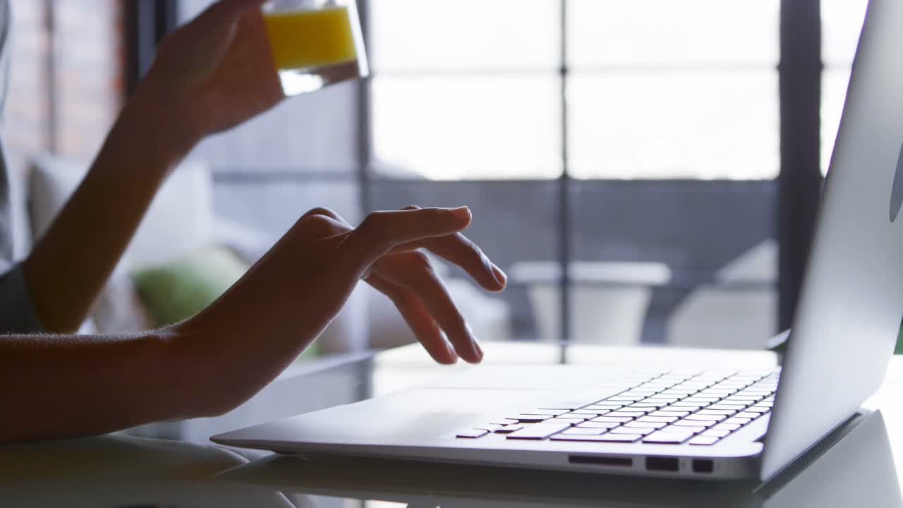 Woman using laptop at home 4k