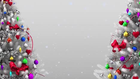 Animation-of-snow-falling-over-two-decorated-christmas-tree-against-copy-space-on-grey-background