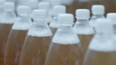 conveyor belt with bottles for juice or water at a modern beverage plant. modern production of sweet soda water