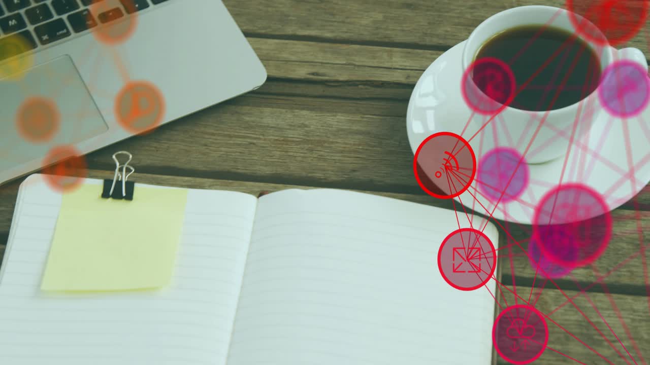 Overhead trackpad view starting, panning right revealing notebook with sticky note, overlay, mug