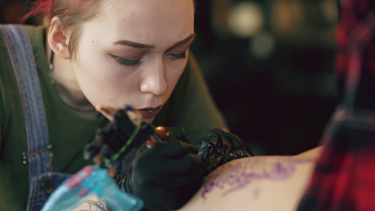 Tattoo Artist Working on a Back Tattoo