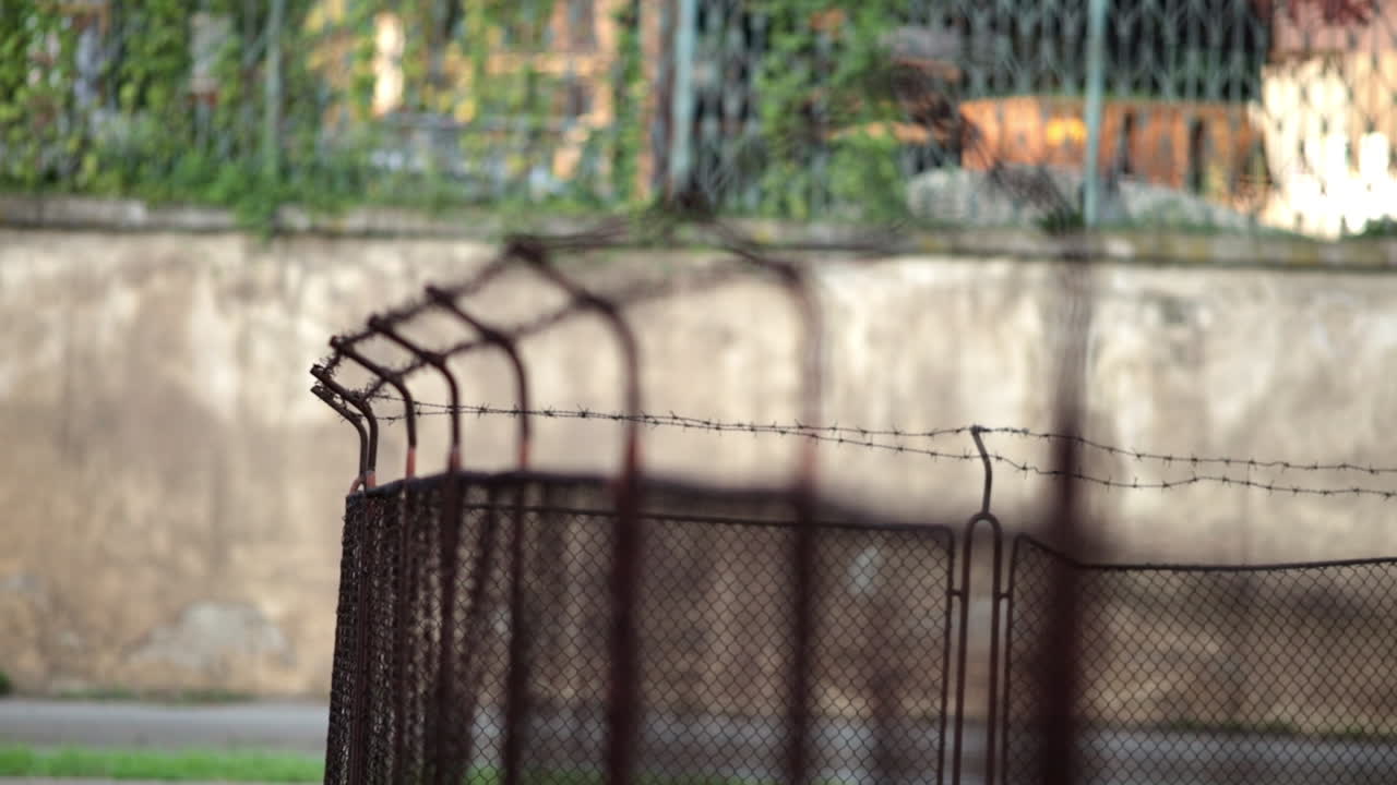 Old fence with barbed wire next to the road