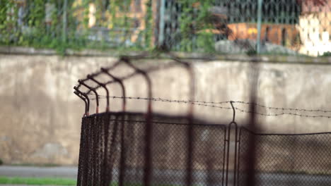 Old fence with barbed wire next to the road