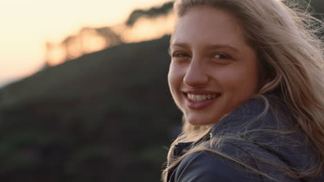 portrait of happy woman laughing having fun on summer vacation enjoying seaside at sunset with wind blowing hair